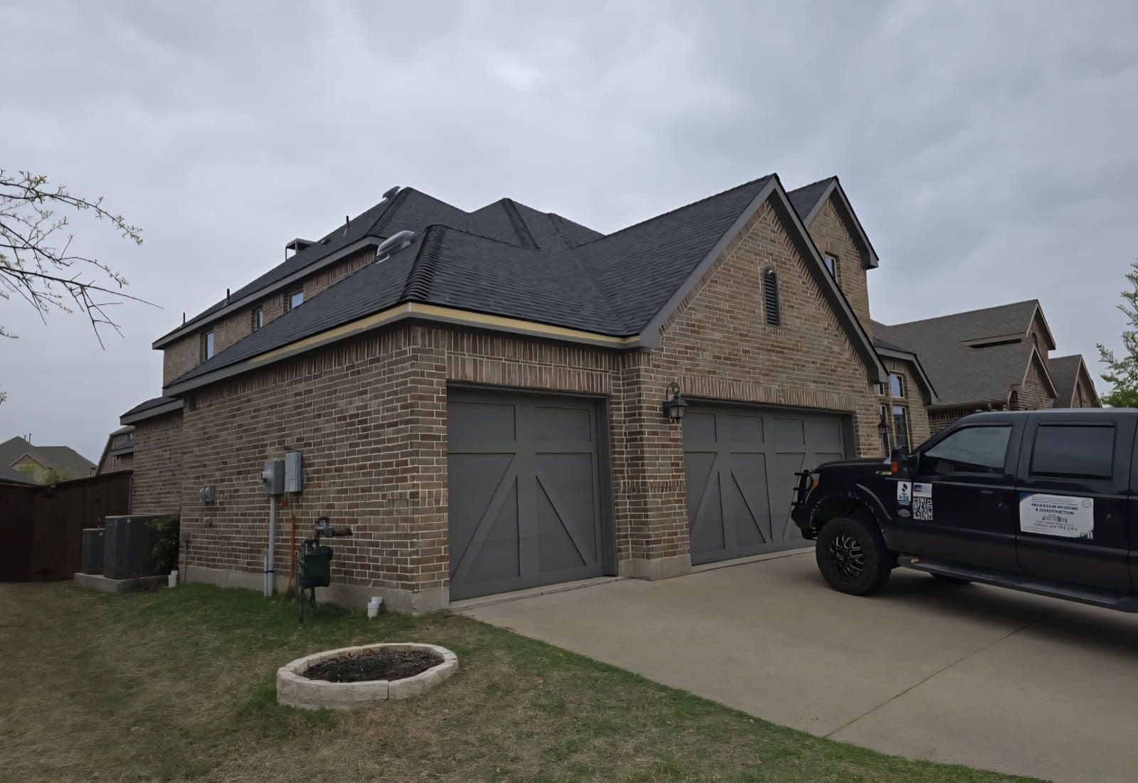 Stylish Dark Shingle Roof for Brick Home image